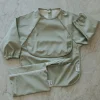 Long-sleeved Bib with integrated pocket 6-24m - Sage